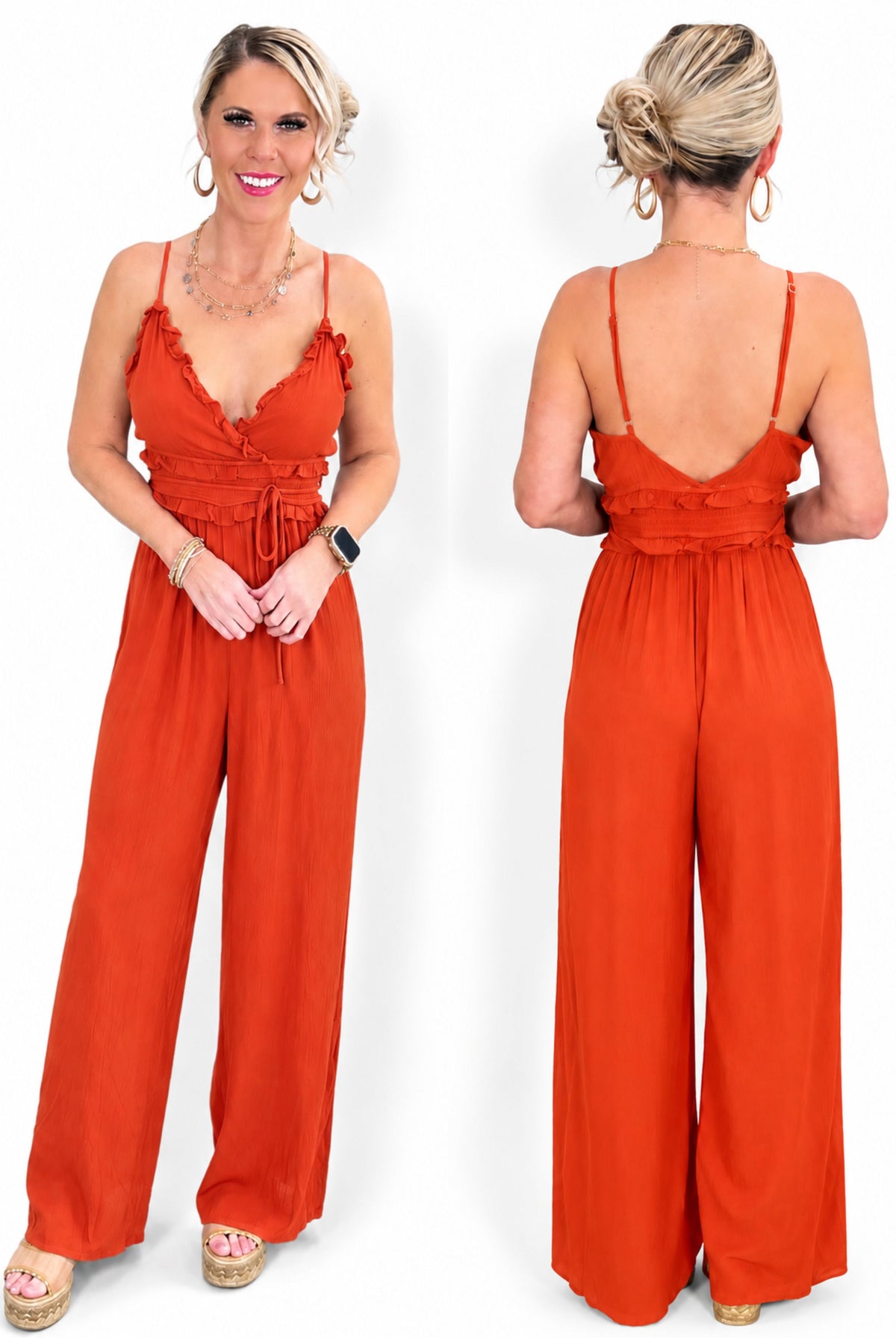 A woman modeling a bright rust-orange wide-leg jumpsuit.