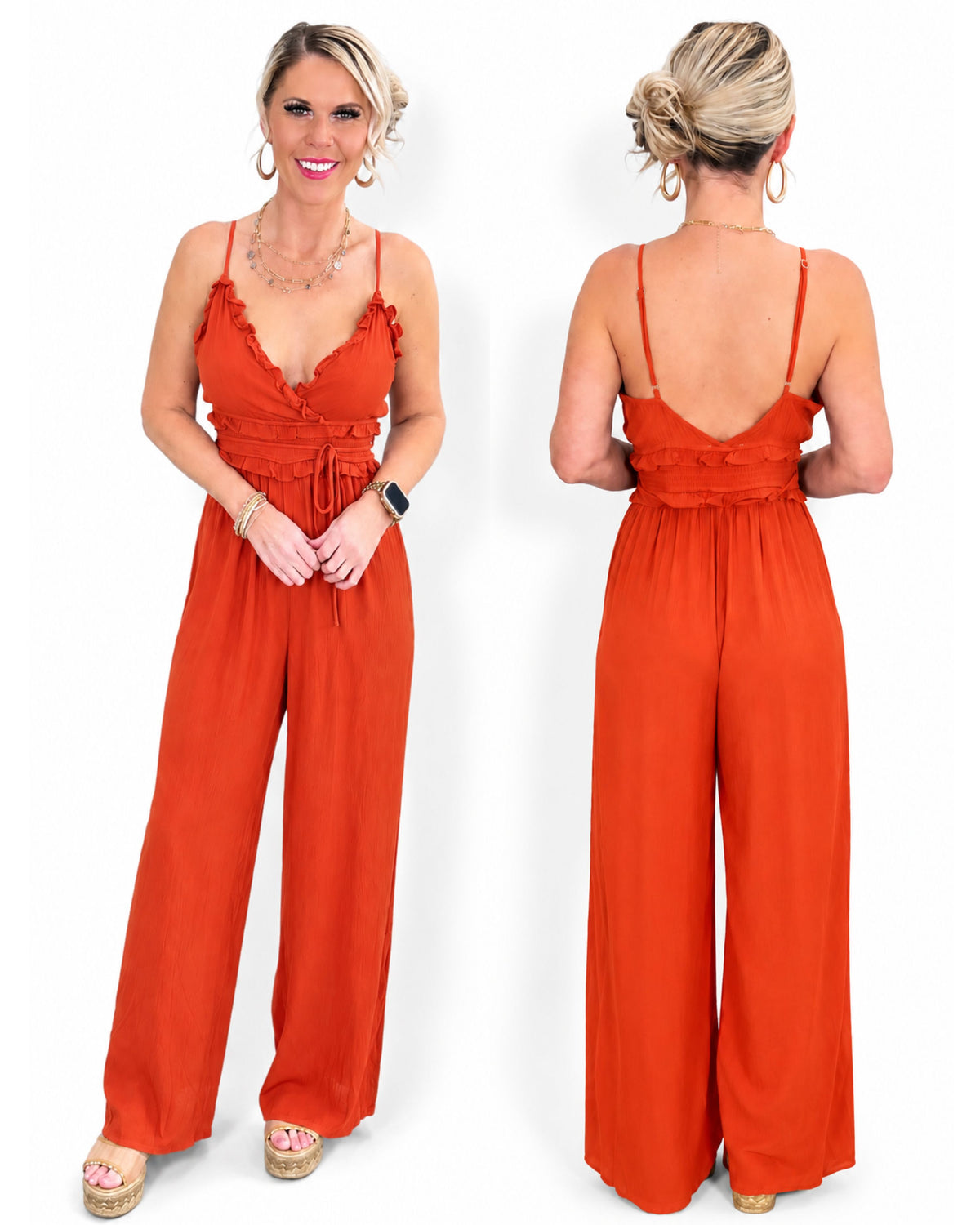 A woman modeling a bright rust-orange wide-leg jumpsuit.