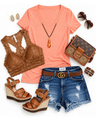 Peach deep V Neck top with denim jeans about a cute brawl and sparkly earrings