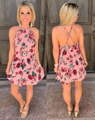Floral dress with ruffles crisscross open back paired with earrings and some cute wedges and a long neck necklace.